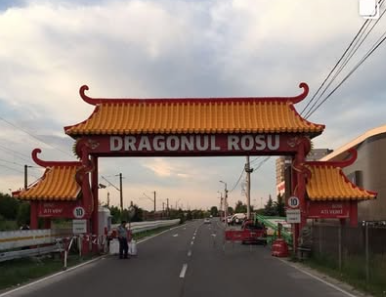 Monumental themed gateway bearing the Dragonul Roșu name